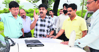 Dehradun District Magistrate R. Meenakshi Sundram along with DIG Police Sanjay Gunjial inspects the proposed site of the new Assembly building at Raipur in Dehradun on Monday.