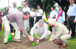 Dr P.P. Bhojvaid, Director of Forest Research Institute, plants a sapling during the vanmahotsav function held at the institute in Dehradun on Monday.