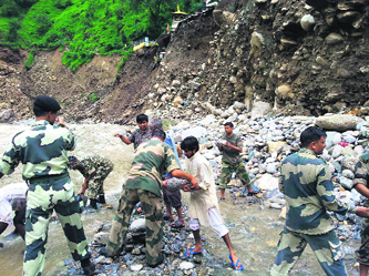 BSF jawans prepare a retaining wall to protect the Kalimath temple in Garhwal.