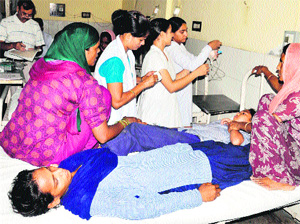 Schoolchildren admitted to Kalpana Chawla Govt Medical College in Karnal on falling ill after taking iron tablets at Randauli village on Monday. 