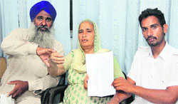 Dilbagh Singh, his wife Gurbaksh Kaur and their son Gurpal Singh showing a copy of the application submitted to the SSP in Jalandhar on Monday.