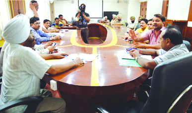 MC officials during the auction of parking sites in Ludhiana on Monday.