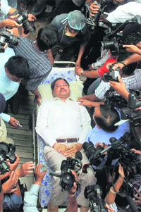 Gujarat Police officer PP Pandey leaves for court on a stretcher in Ahmedabad on Monday