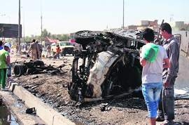 People gather at the site of a car bomb explosion in Sadr City, Baghdad, on Monday.
