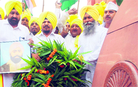 Members of the All-India Anti-Terrorist Front (Punjab) pay tributes to freedom fighter Shaheed Udham Singh at Jallianwala Bagh in Amritsar on Tuesday.
