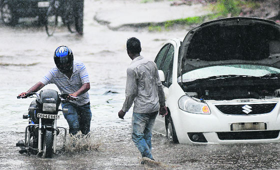 A biker wades through a waterlogged road in the Industrial Area, Phase I, in Chandigarh on Tuesday.