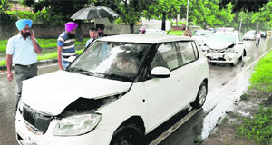 Commuters look at cars damaged in a pile-up on road separating Sectors 36 and 37 in Chandigarh on Tuesday.