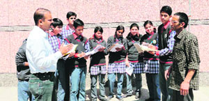 Dr Rahul Gaud, a science teacher, discusses a survey project on hypertension with students of Kendriya Vidyalaya in Mussoorie on Tuesday. 