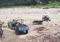 Tractor-trailers engaged in illegal mining in one of the rivers in Kangra. 