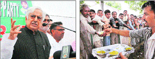 PDP patron Mufti Mohammad Sayeed speaks during the foundation day function of the PDP; and (right) a worker distributes sweets at the function in Jammu on Tuesday. 
