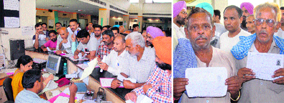 Applicants at Suwidha Centre crowd the reception area for getting affidavits; and (right) applicants for Aadhar Card show their token slips at Suwidha Centre in Jalandhar on Tuesday.