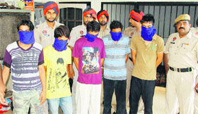 Policemen with the arrested snatchers in Jalandhar on Tuesday. 