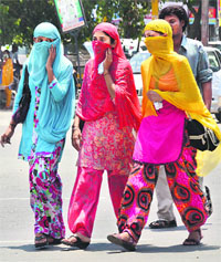 Girls protect themselves from scorching heat in Ludhiana.