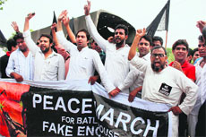 Residents take out a peace march demanding justice in Batla encounter case in New Delhi on Tuesday.