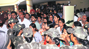 Policewomen have a word with protesting medical graduates during counselling at Baba Farid University of Health Sciences, Faridkot, on Tuesday.