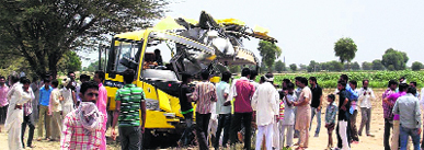 The mangled remains of the school bus that collided with a truck near Sriganganagar on Tuesday. 