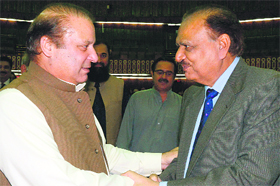 Pakistan PM Nawaz Sharif greets newly elected President Mamnoon Hussain in Islamabad on Tuesday.