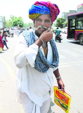 Prized possession: Adorning a colorful Rajasthani turban, a man twirls his moustache near the Bathinda Bus Stand on Wednesday