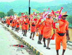 Kanwariyas carry jal from the Ganga in Haridwar on Wednesday.