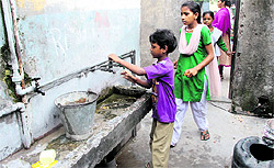 Students drink water from a tap at a government school in Jalandhar