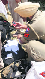 A policeman searches belongings of victims.