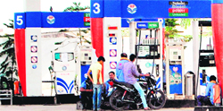 Customers at a petrol pump in Amritsar on Thursday. Photo: Sameer Sehgal