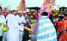 Members of the Muslim community give refreshments to Kanwariyas at the Jwalapur Kanwar patri in Haridwar on Thursday. 