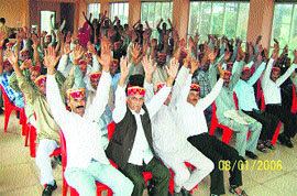 The Gaddi community raise their hands to pass a resolution at a meeting in Palampur on Thursday.