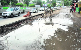 Tinted glasses: The cavalcade of Punjab CM passing through old GT road which is in deplorable condition with water accumulated on the broken road. 