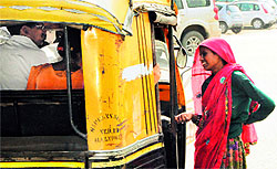 A woman seen begging on a busy traffic intersection in the city