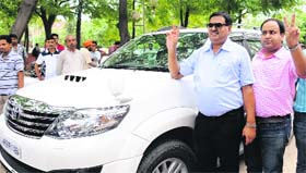 Pawan Kumar Mittal and his son after buying the 0001 vanity number in Chandigarh on Friday