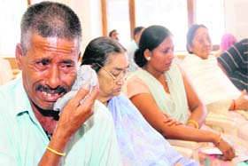 A father who lost his son cries at the function