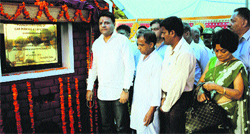 Minister for Urban Development and House and Town Planning Sudhir Sharma lays the foundation stone of a car paking in Dharamsala on Friday. Photo: Kamaljeet