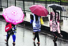 Girls walk through the rain