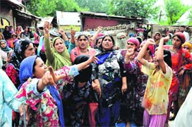 Villagers hold protest against the alleged high-handedness of the police in Kulgam on Friday
