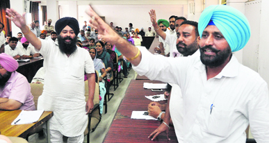 Independent councillor Daljit Singh Grewal (right) and his supporters demand cancellation of an FIR lodged against him during the MC General House meeting in Ludhiana on Friday.