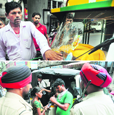 Driver of an auto shows the broken windscreen; and (above) policemen record his statement near Mata Rani Chowk, Ludhiana, on Friday.