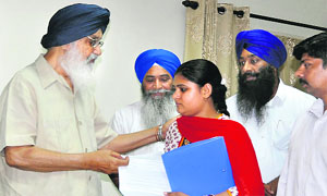 Chief Minister Parkash Singh Badal hands over an appointment letter to Sarabjit Singhs daughter Swapandeep Kaur in Jalandhar on Friday. 