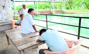 Family members of the victims, who were aboard the bus that plunged into the Bhakra canal, wait as the rescue operation goes on at the Khanori Bhakra Head on Friday. 