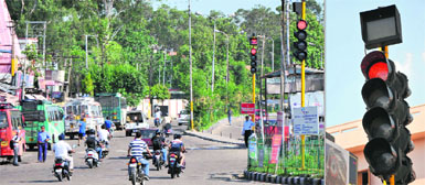 Commuters show disregard for traffic signals at Bikram Chowk on Saturday; (right) digital timers of the traffic lights in Kachi Chawni area are non-functional.
