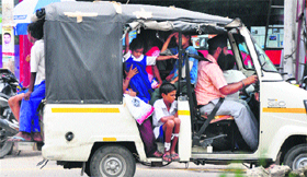 An overloaded auto-rickshaw continues to ferry children to school in Ludhiana.