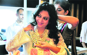 A woman tries a neck piece during an exhibition at a hotel in Ludhiana on Saturday.