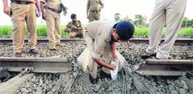 Policemen inspect a railway track after a blast, suspected to be triggered by Maoists, near Gaya on Saturday.