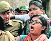 Suspected Maoist Joyeeta Das shouts slogans against the TMC government outside a Kolkata court on Saturday. She was arrested on Friday.