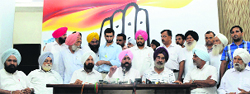 PPCC chief Partap Singh Bajwa along with the affected farmers from Gujarat addresses a press conference in Chandigarh on Saturday. A Tribune photograph