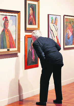 A visitor takes a close look at a painting by Peruvian artist Jose Sabogal (1888-1956), during an exhibition of the latter’s work at Lima’s Art Museum (MALI).