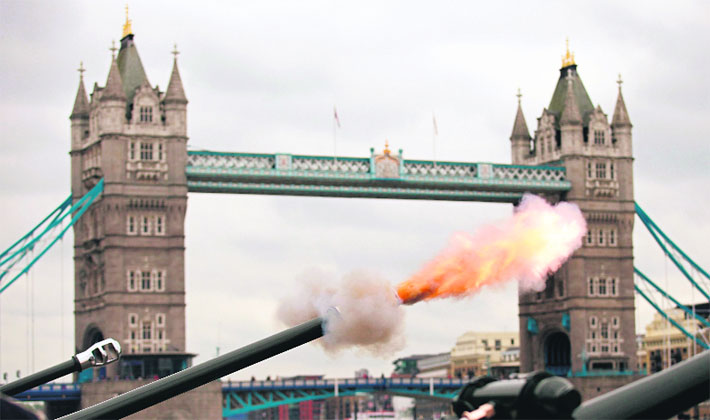 Soldiers fire a 62-round royal gun salute at the Tower of London in London. 