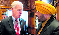 Wisconsin Sen. Ron Johnson (L) speaks with Harcharan Gill, the trustee of the Milwaukee-area Sikh temple, in Milwaukee