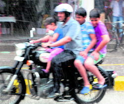 A family enjoys early morning showers in Amritsar on Sunday.