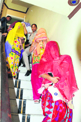 Women allegedly involved in the racket being arrested during a raid at an SCF near Mittal Mall on the Bathinda-Goniana road on Sunday.